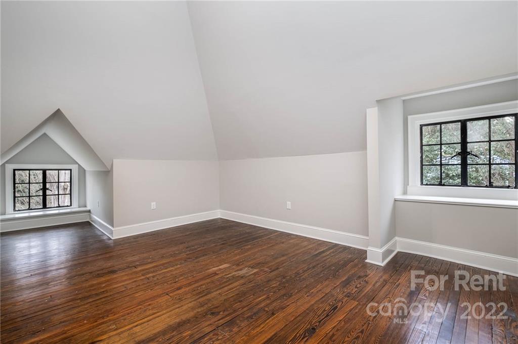 1107 Queens Road Charlotte, NC 28207 - Photo 39 of 44 an empty room with wooden floor and windows