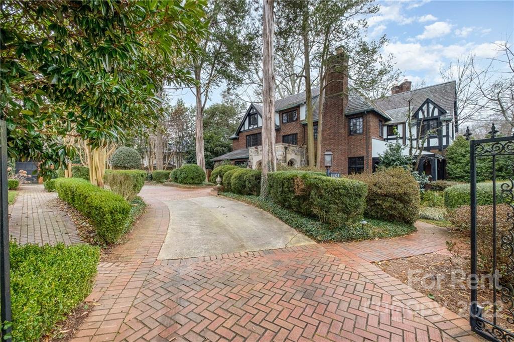 1107 Queens Road Charlotte, NC 28207 - Photo 4 of 44 a front view of a house with a yard and trees
