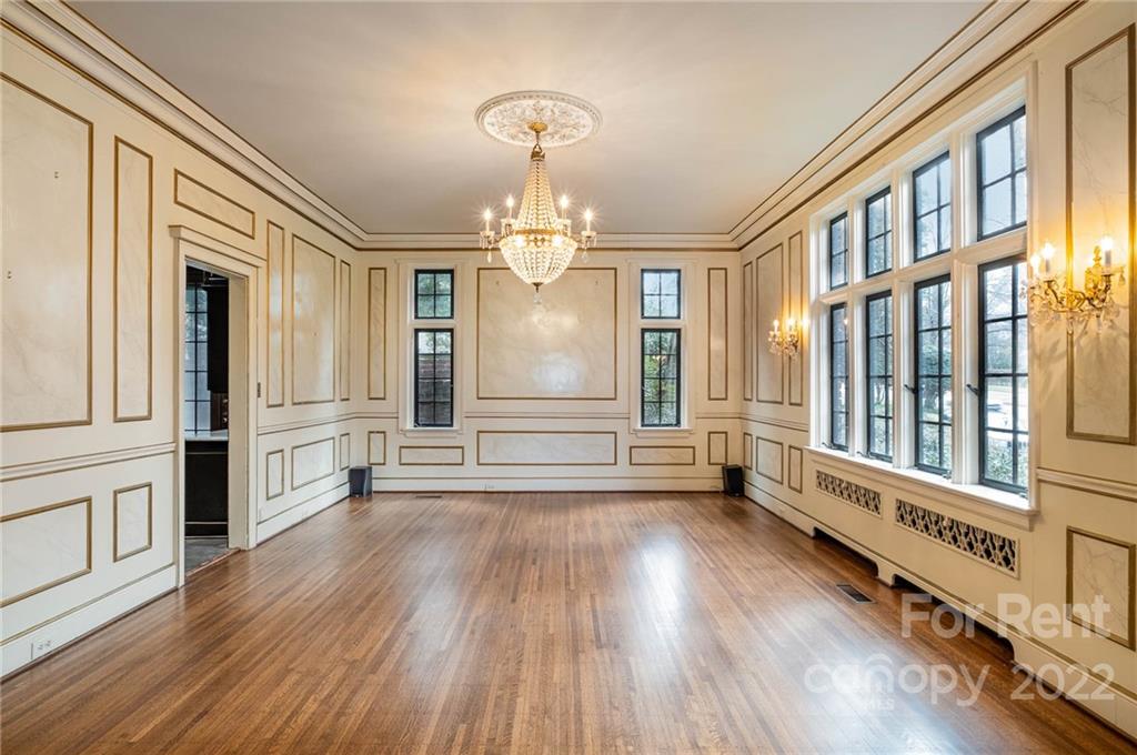 1107 Queens Road Charlotte, NC 28207 - Photo 7 of 44 a view of a big room with wooden floor and windows