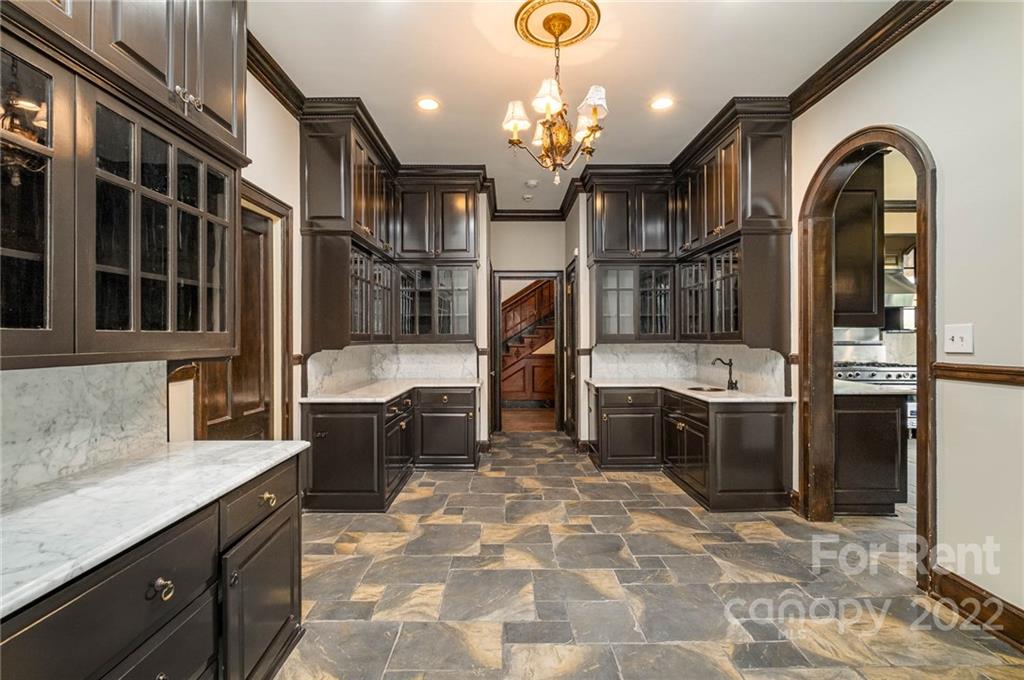 1107 Queens Road Charlotte, NC 28207 - Photo 10 of 44 a large kitchen that has a lot of cabinets in it