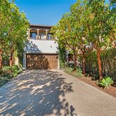 a front view of a house with a yard and tree