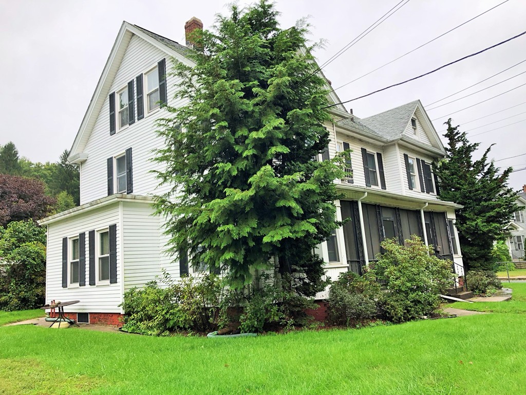 2022-2024 Palmer Road Three Rivers, MA 01080 - Photo 1 of 30 a front view of a house with a yard and trees