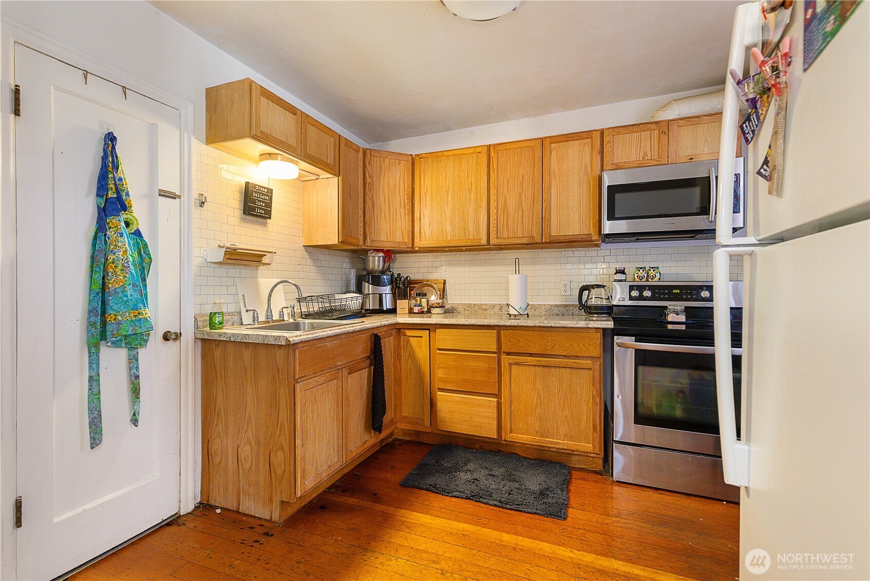 2601 Rucker Avenue Everett, WA 98201 - Photo 21 of 39 a kitchen with stainless steel appliances granite countertop a stove a sink and a refrigerator