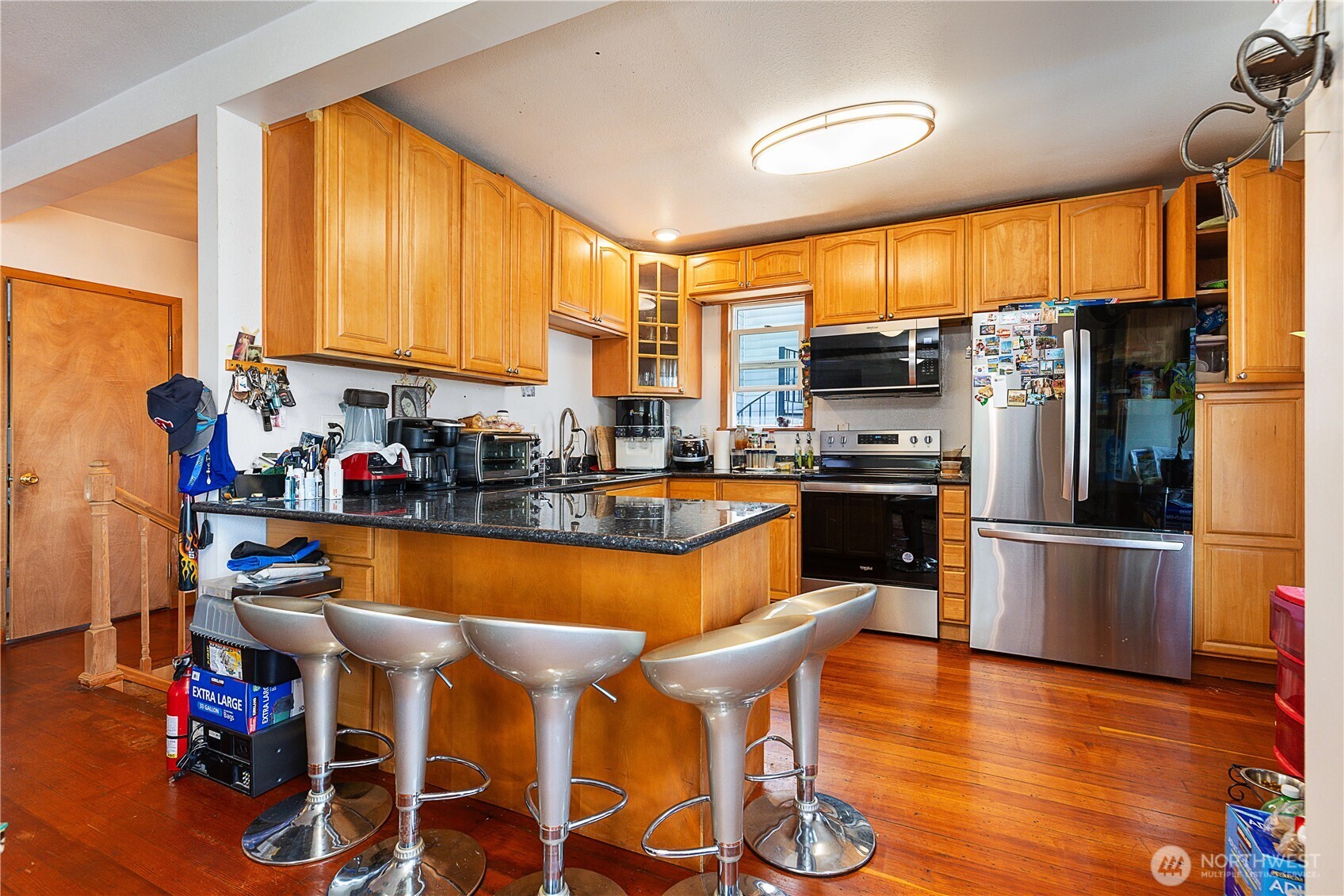 2601 Rucker Avenue Everett, WA 98201 - Photo 31 of 39 a large kitchen with a table chairs refrigerator and a large window