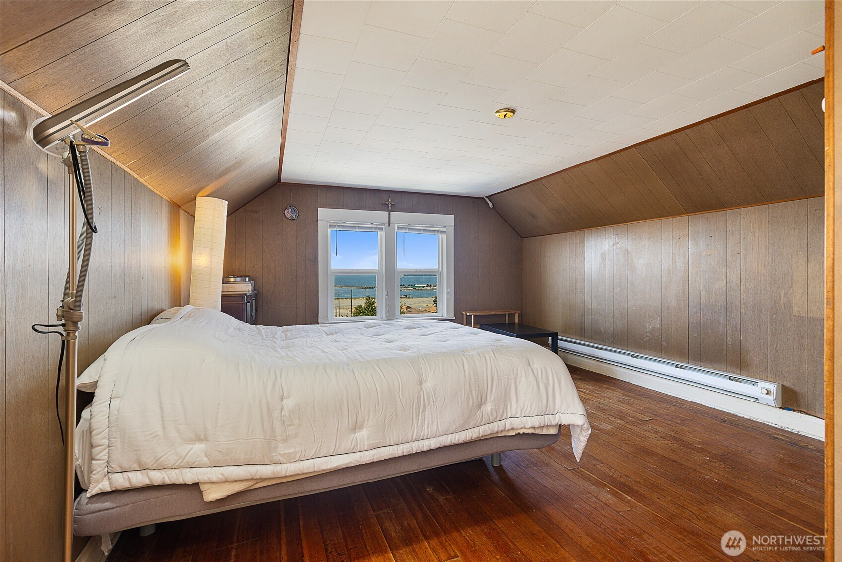 2601 Rucker Avenue Everett, WA 98201 - Photo 36 of 39 a bed sitting in a spacious bedroom next to a window and chandelier