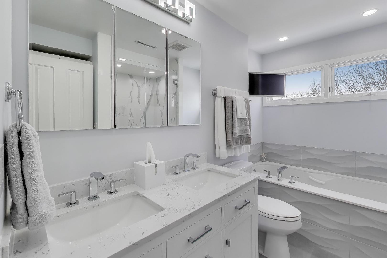 1459 West Wrightwood Avenue, Unit 1459 Chicago, IL 60614 - Photo 23 of 40 a bathroom with a sink double vanity granite and a toilet
