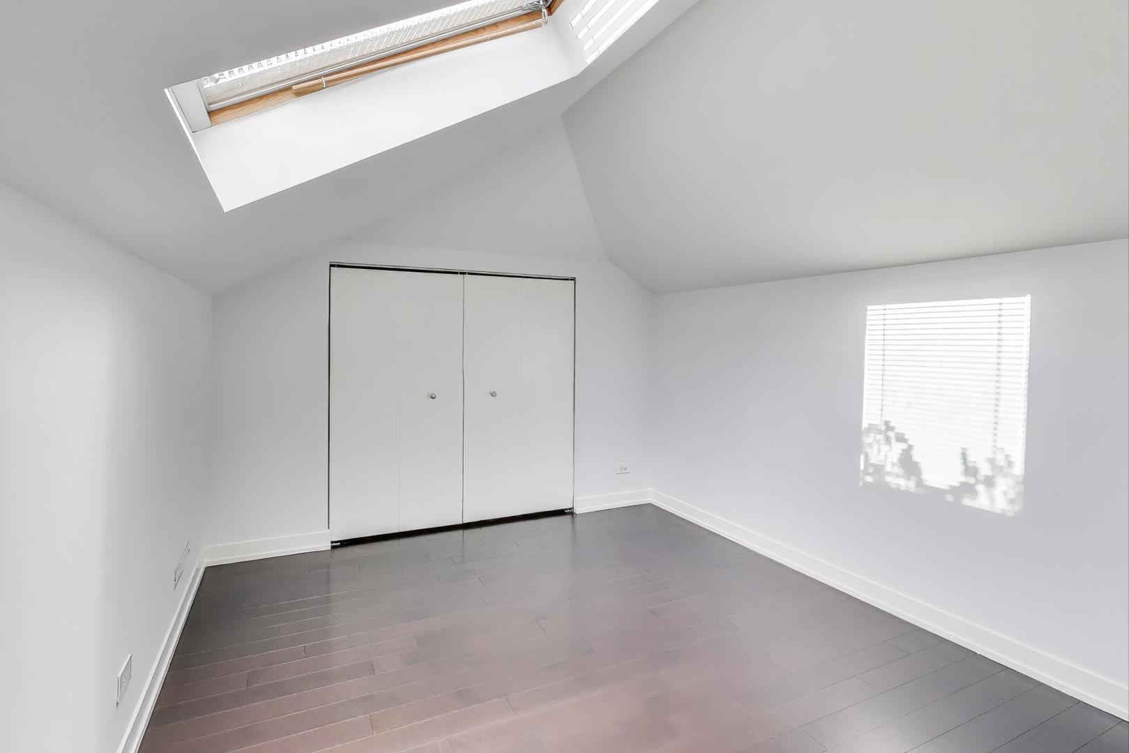 1459 West Wrightwood Avenue, Unit 1459 Chicago, IL 60614 - Photo 30 of 40 an empty room with wooden floor and windows