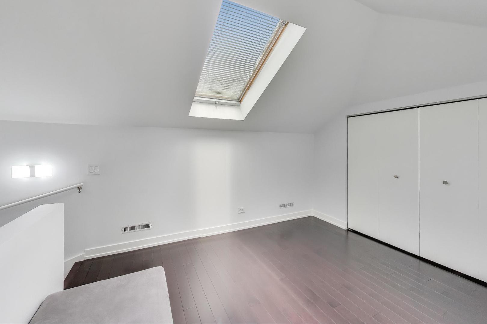 1459 West Wrightwood Avenue, Unit 1459 Chicago, IL 60614 - Photo 31 of 40 an empty room with wooden floor and windows