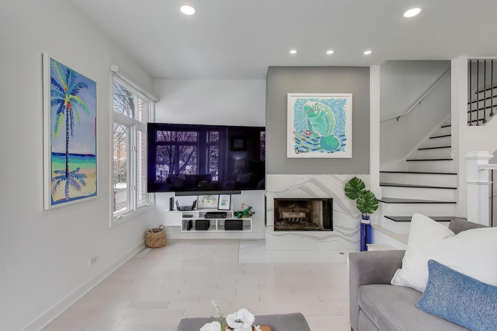 1459 West Wrightwood Avenue, Unit 1459 Chicago, IL 60614 - Photo 10 of 40 a living room with furniture a fireplace and a flat screen tv