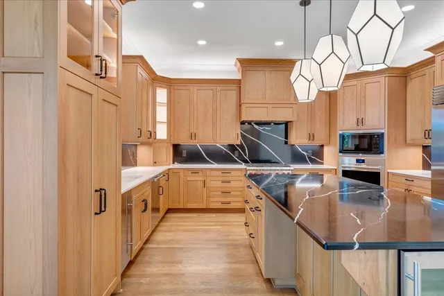 an aerial view of a house with a yard and lake view