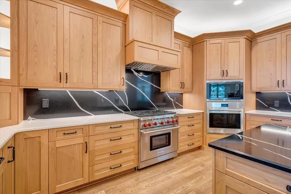 an aerial view of a house with swimming pool patio and outdoor seating