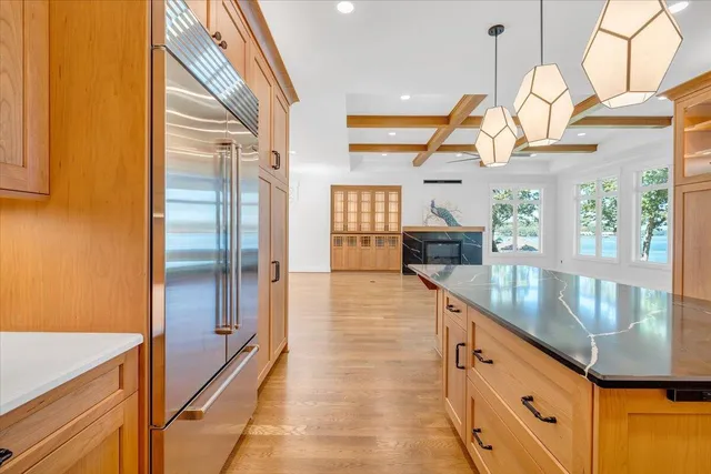 a view of a house with a yard and large tree