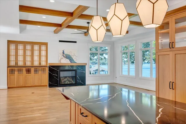 a front view of a house with a yard and trees