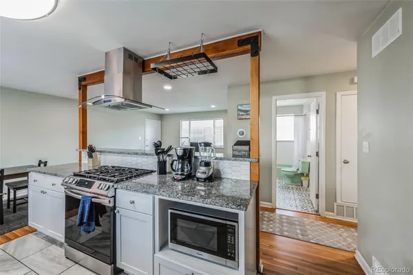 a kitchen with stainless steel appliances granite countertop a stove and a refrigerator