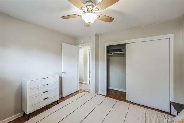 a view of an empty room and chandelier fan