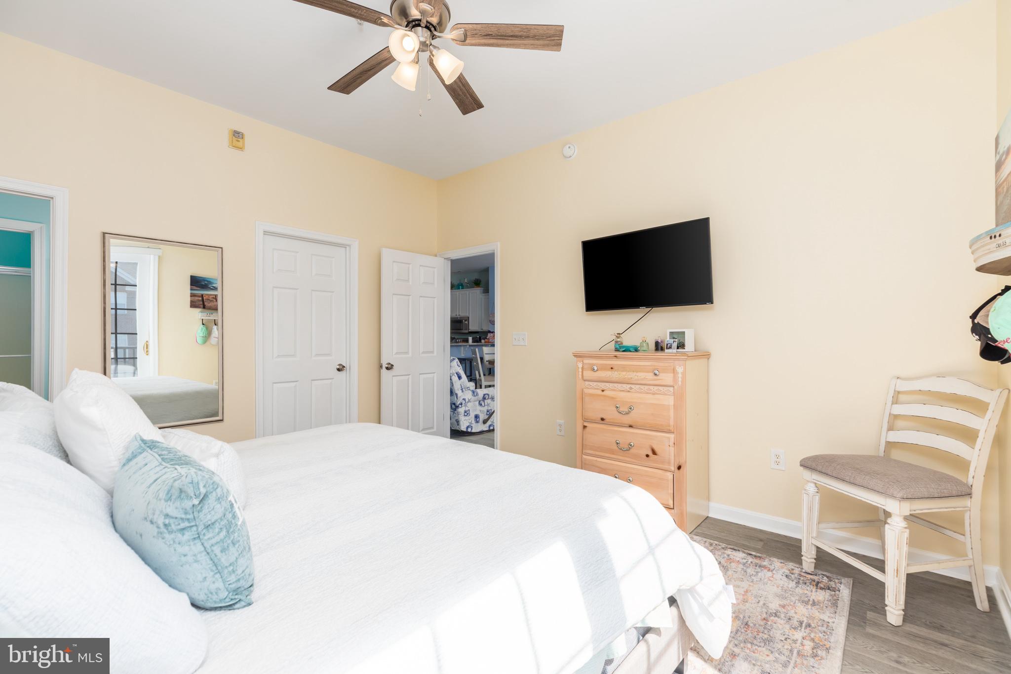 17300 North Village Main Boulevard, Unit 66 Lewes, DE 19958 - Photo 13 of 38 a bedroom with a bed and a flat screen tv