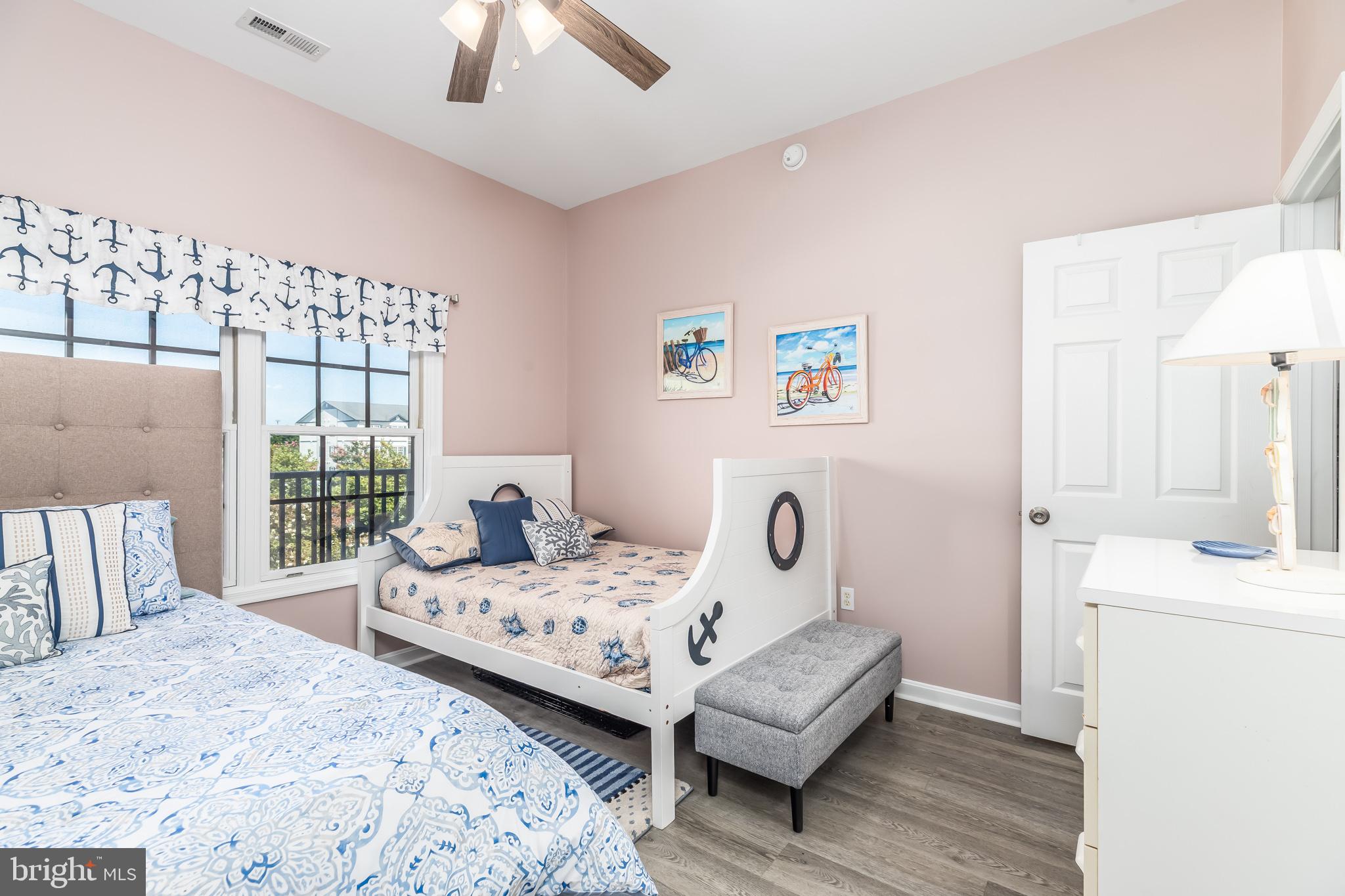 17300 North Village Main Boulevard, Unit 66 Lewes, DE 19958 - Photo 19 of 38 a bedroom with a bed and a chandelier