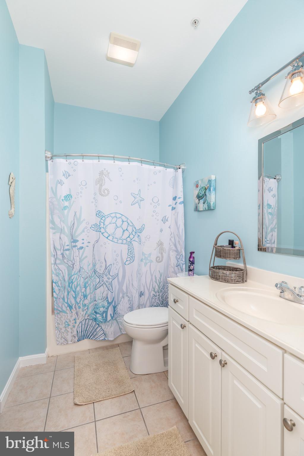 17300 North Village Main Boulevard, Unit 66 Lewes, DE 19958 - Photo 21 of 38 a bathroom with a granite countertop sink a toilet and a shower