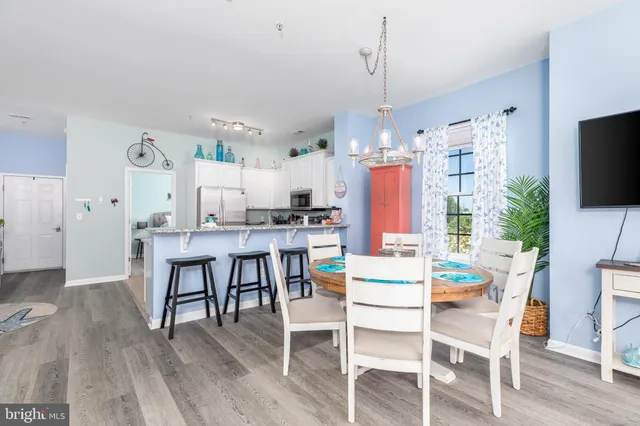 a kitchen with kitchen island a dining table and chairs