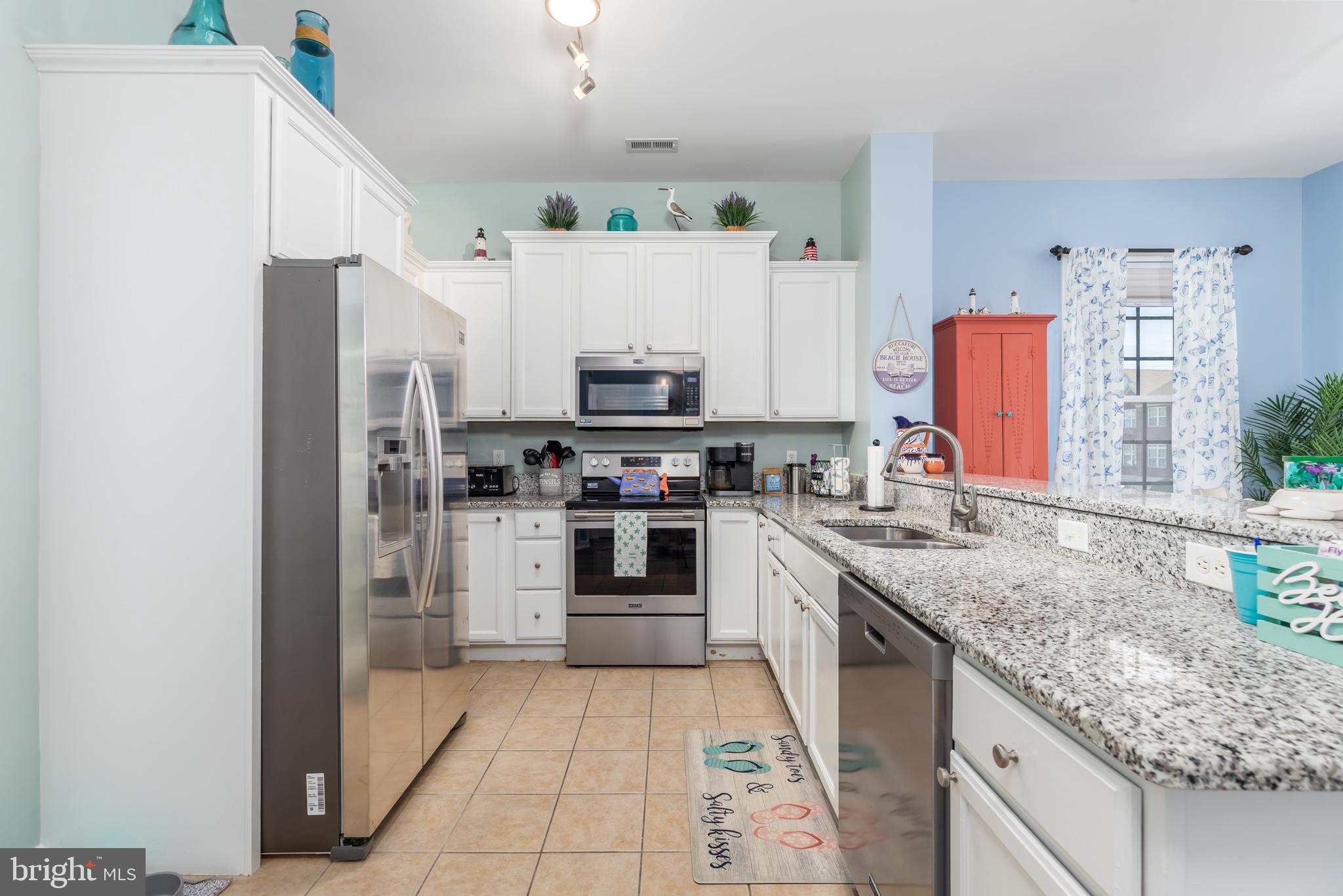 17300 North Village Main Boulevard, Unit 66 Lewes, DE 19958 - Photo 6 of 38 a kitchen with stainless steel appliances granite countertop a refrigerator sink and stove