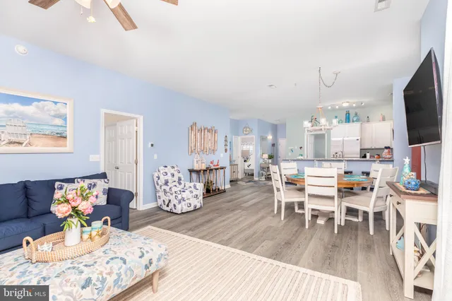 a living room with furniture a flat screen tv and a table