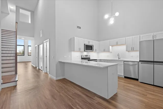 a kitchen with white cabinets and white appliances