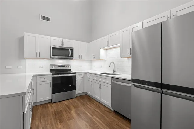 a kitchen with a refrigerator stove and sink