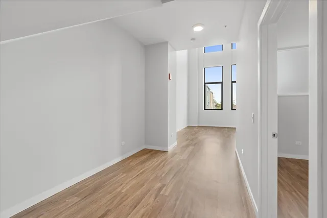 a view of hallway with wooden floor