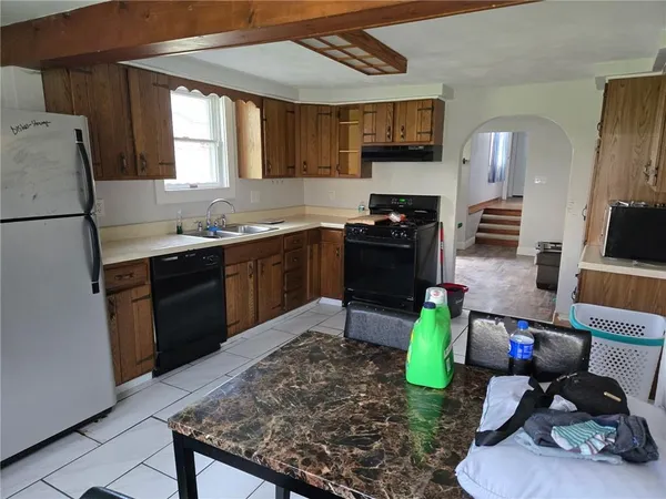 a kitchen with sink refrigerator and stove