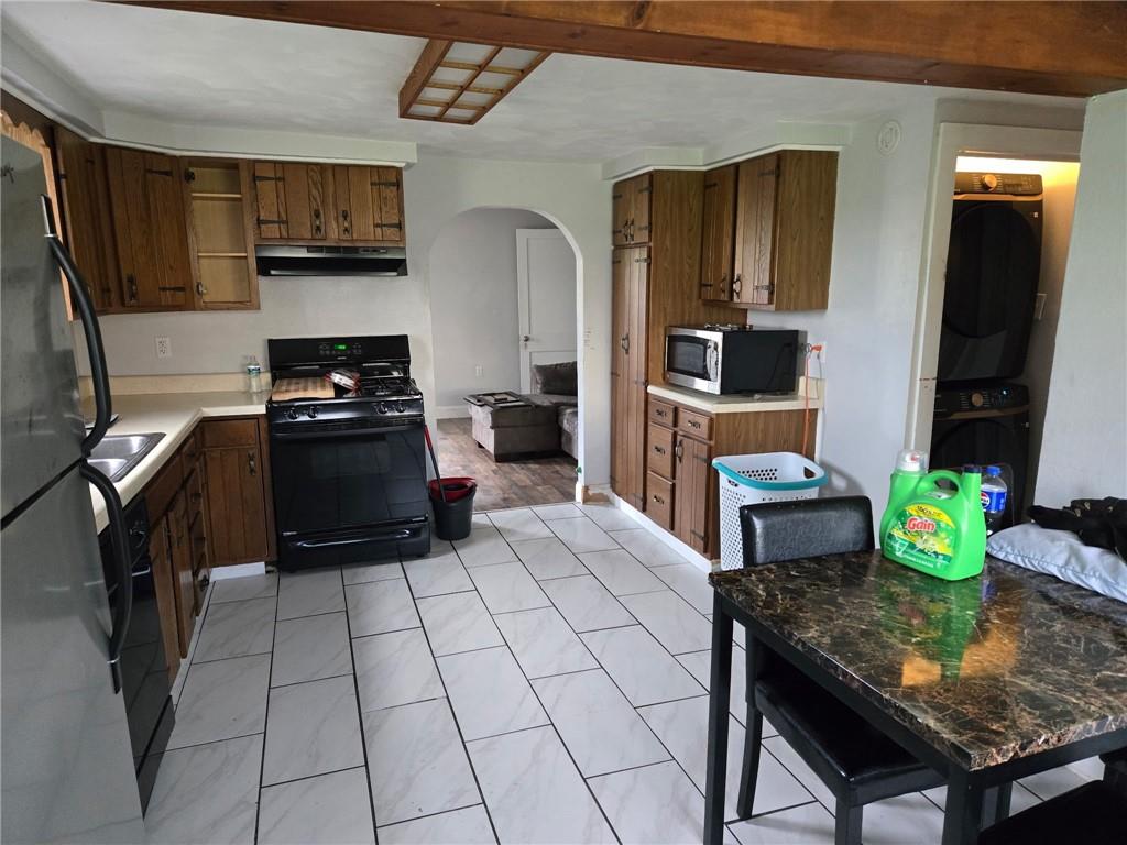 514 Penn High Park Road Jeannette, PA 15644 - Photo 13 of 30 a kitchen with stainless steel appliances kitchen island granite countertop a stove a sink and a microwave