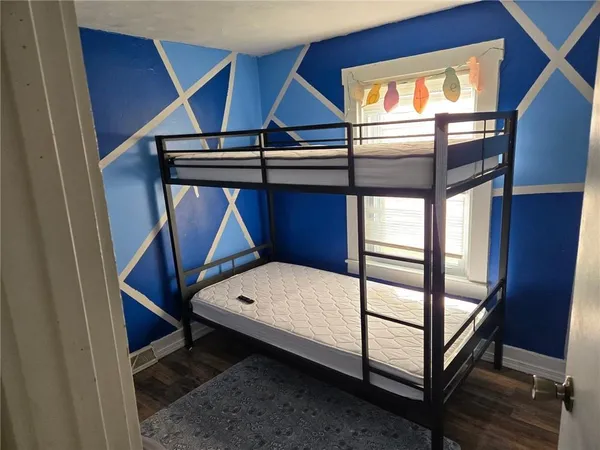 a view of staircase with a rug and a window