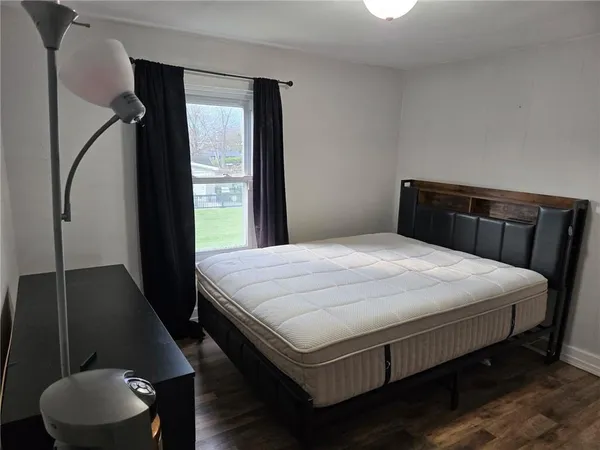 a bedroom with a bed and a dresser