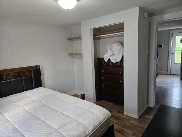a view of a room with wooden floor and windows