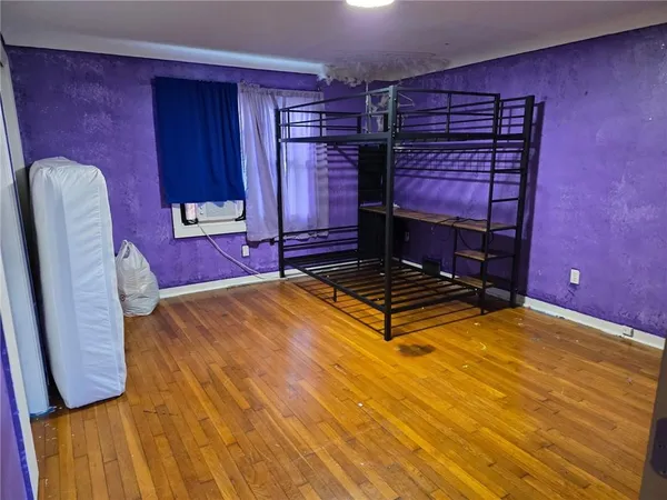 a view of a room with wooden floor and entryway