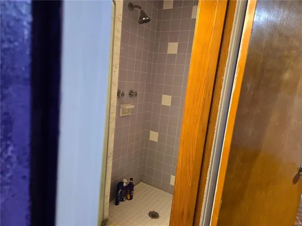 a bathroom with a toilet and a mirror