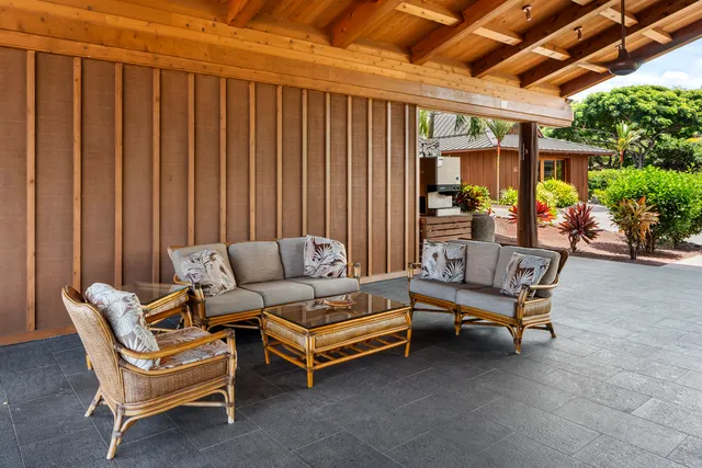 a view of patio with a table and chairs under an umbrella