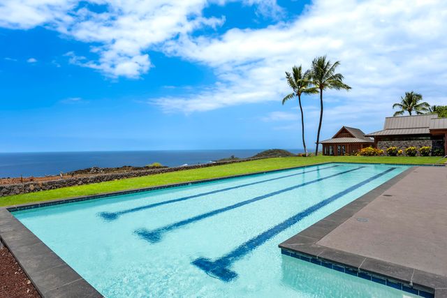 a view of a yard with a house in the background