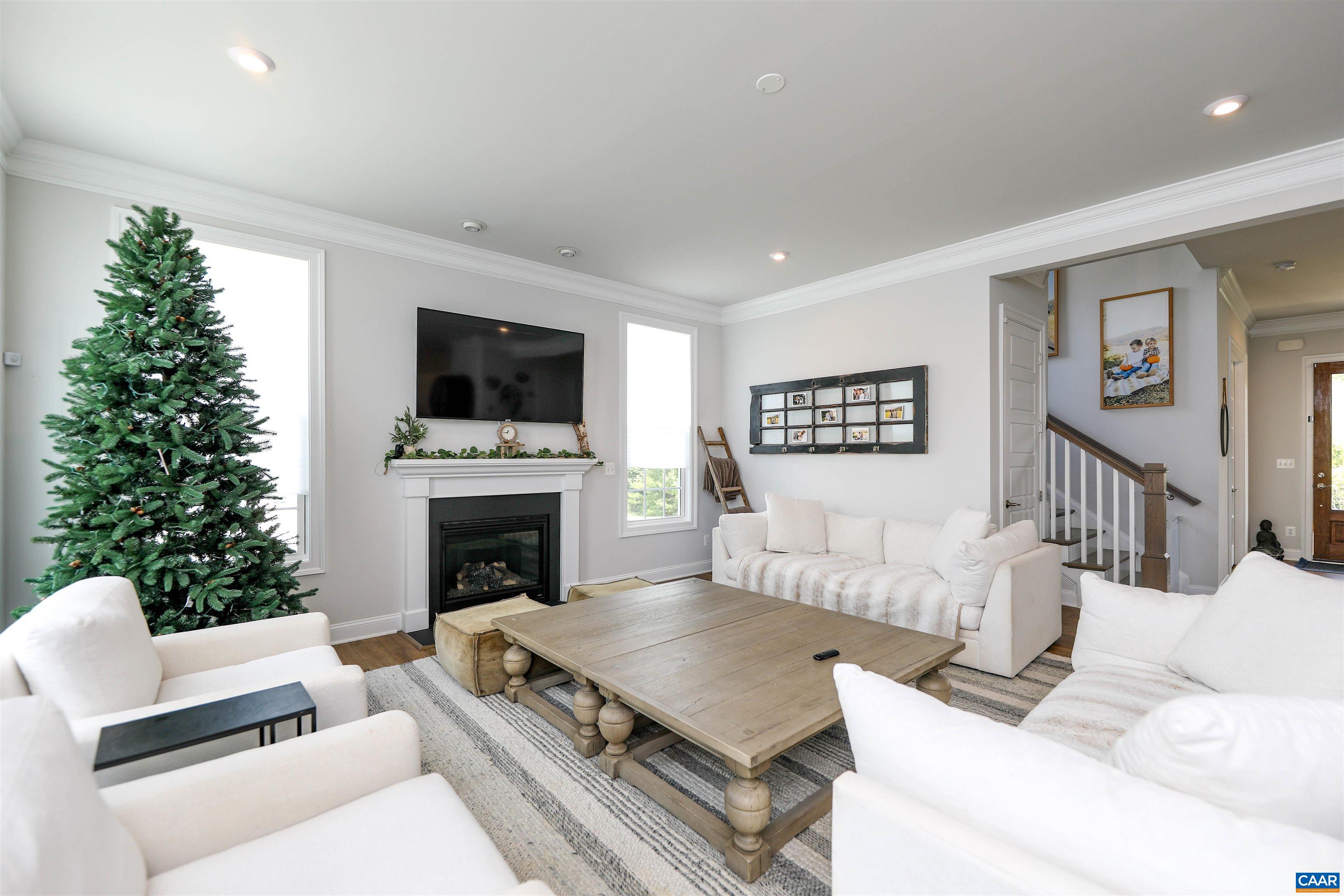 2483 Ferndown Lane Keswick, VA 22947 - Photo 19 of 54 a living room with furniture a fireplace and a flat screen tv