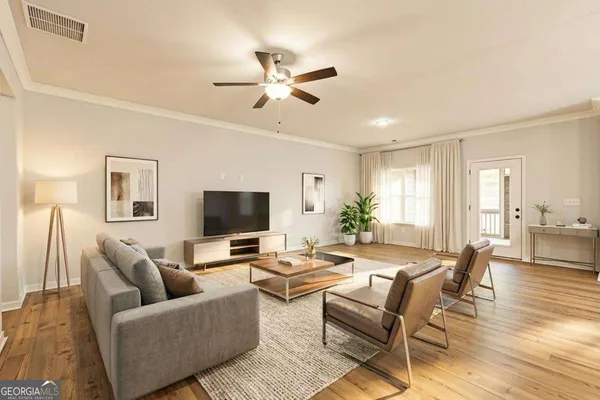a living room with furniture and a flat screen tv