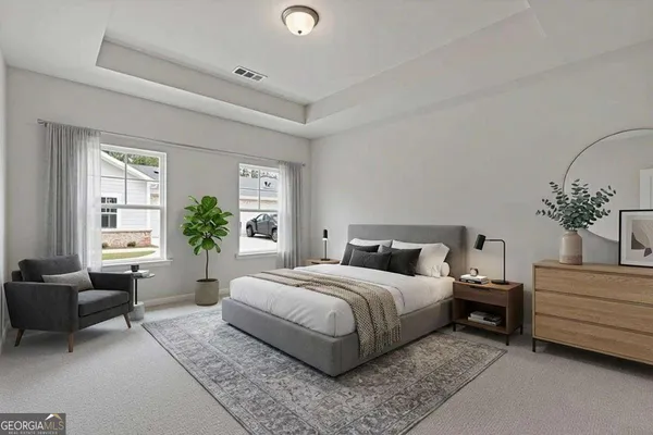 a bedroom with a large bed and a couch