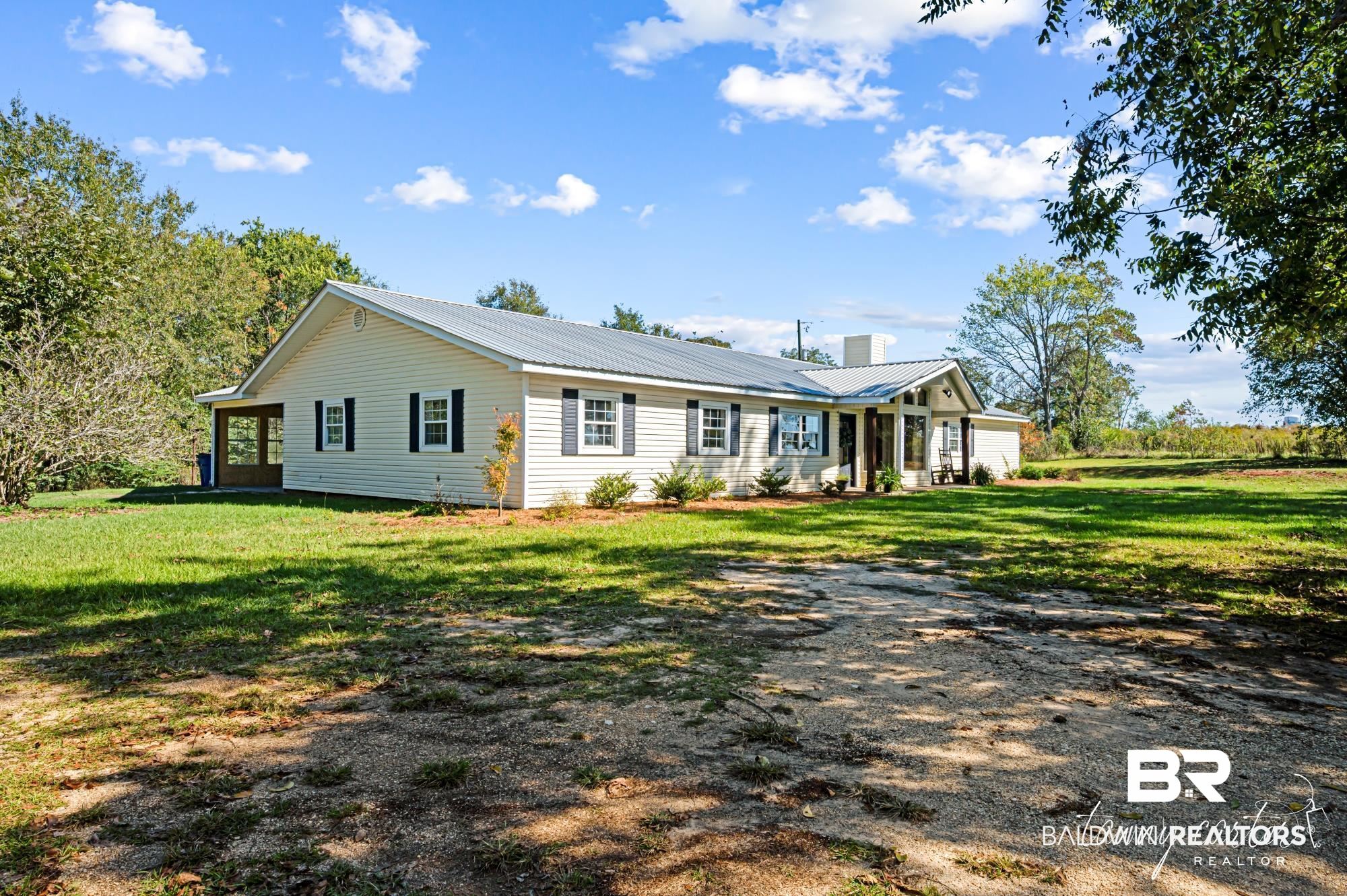 3086 Wild Fork Road Frisco City, AL 36445 - Photo 28 of 30 View of front of house with a metal roof and a front lawn