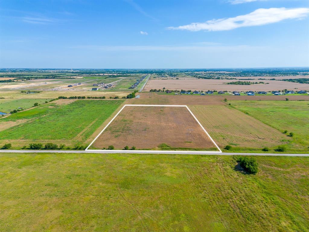 Expansive rectangular parcel with clear boundaries, roadside frontage, and surrounding agricultural land