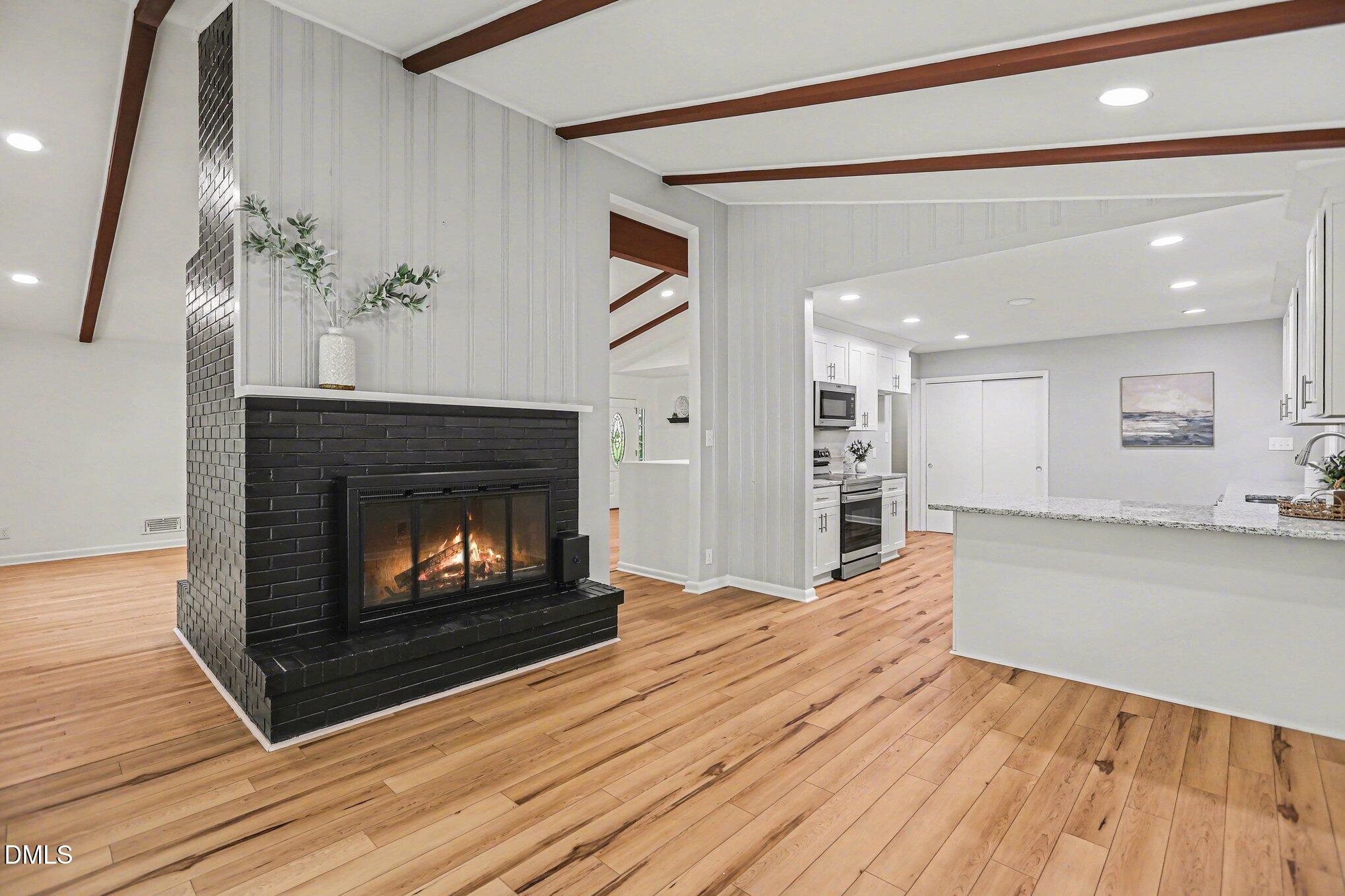 2600 Wade Avenue Raleigh, NC 27607 - Photo 6 of 31 a living room with furniture and a fireplace