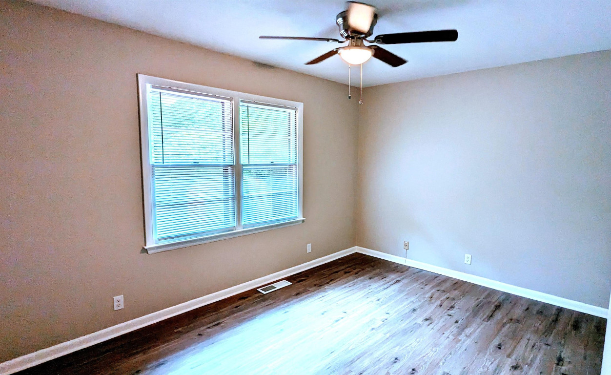 Undisclosed Address Raleigh, NC 27604 - Photo 12 of 32 an empty room with wooden floor and windows