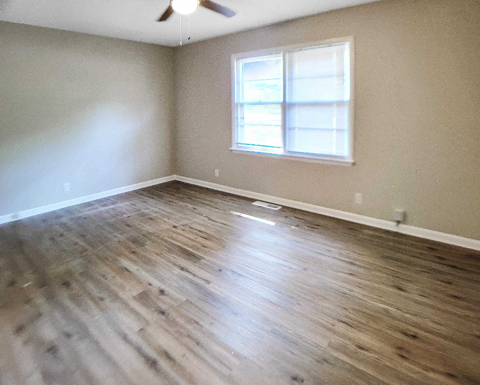 Undisclosed Address Raleigh, NC 27604 - Photo 13 of 32 an empty room with wooden floor and windows