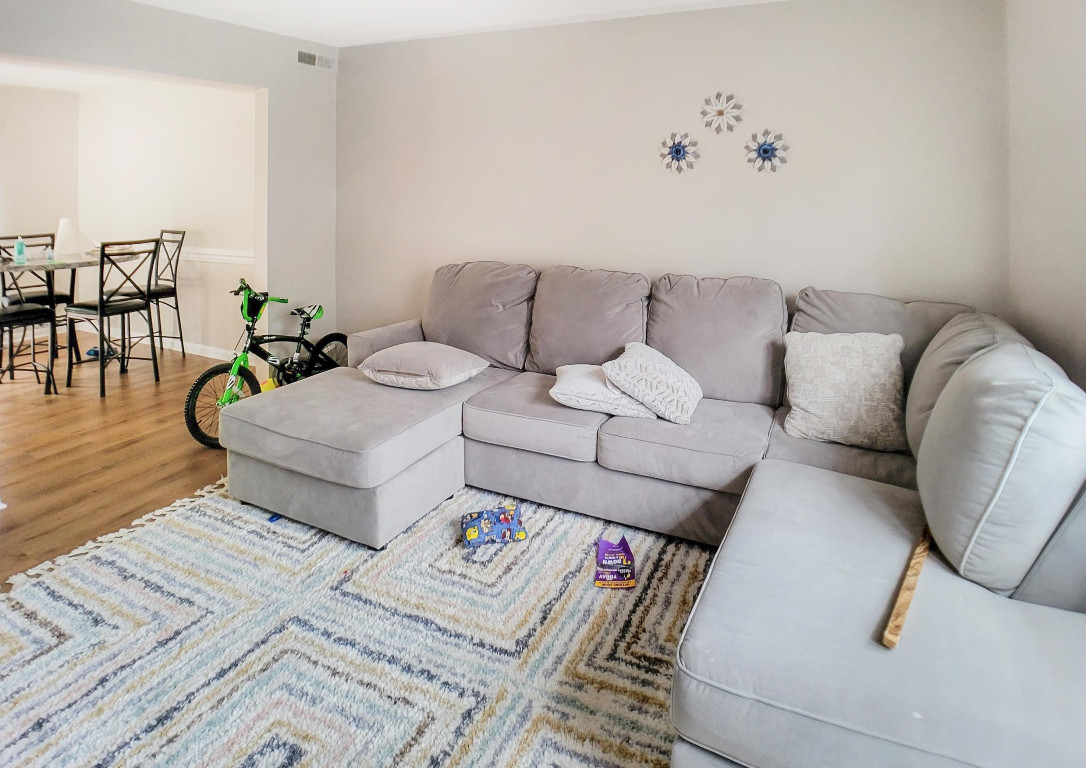 Undisclosed Address Raleigh, NC 27604 - Photo 18 of 32 a living room with furniture and wooden floor
