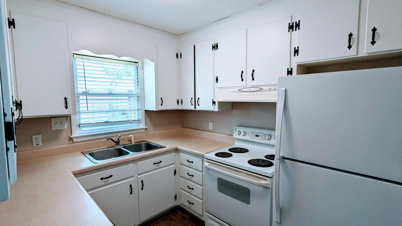 Undisclosed Address Raleigh, NC 27604 - Photo 21 of 32 a kitchen with white cabinets and white appliances