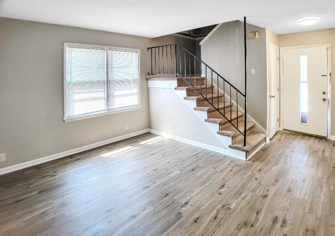 Undisclosed Address Raleigh, NC 27604 - Photo 24 of 32 a view of entryway with wooden floor and stairs