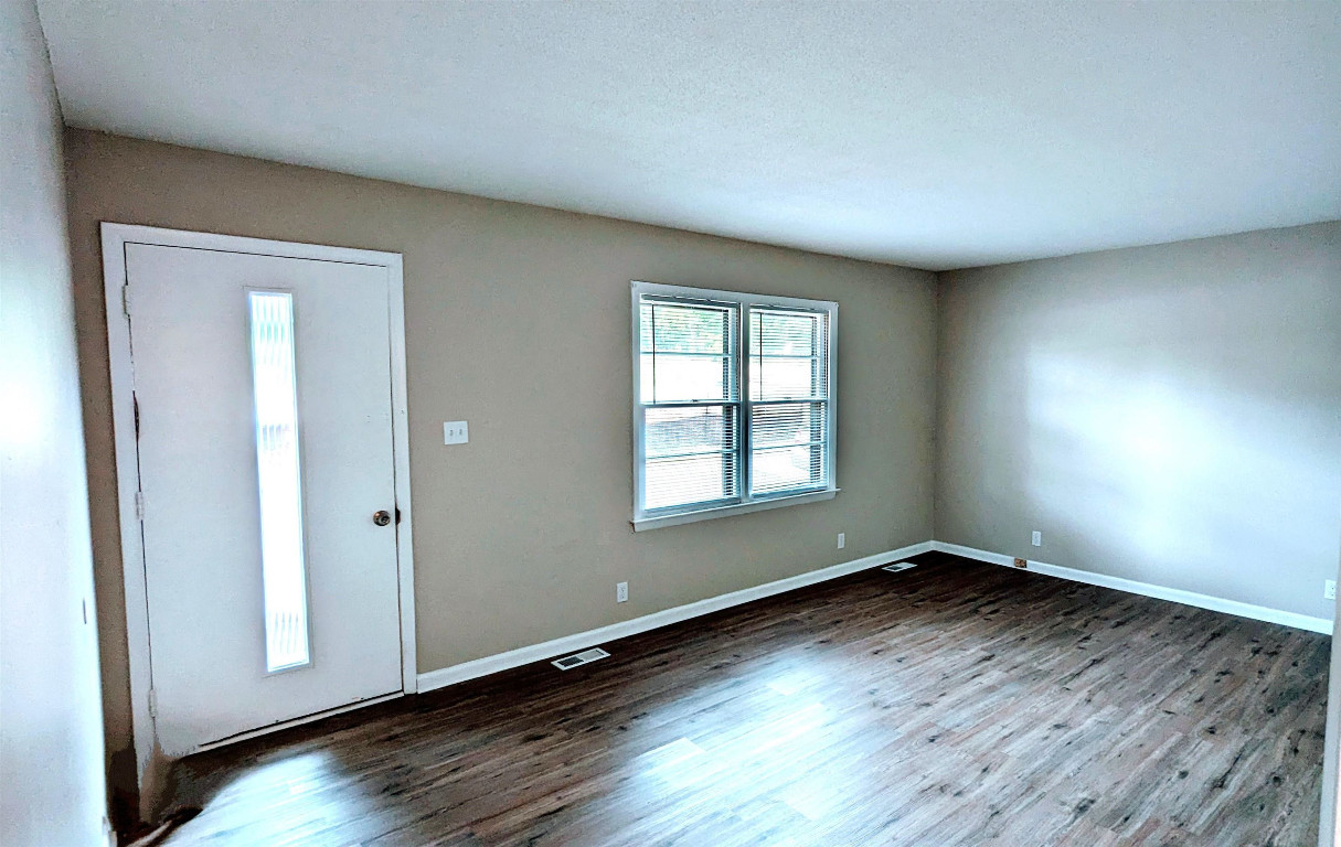 Undisclosed Address Raleigh, NC 27604 - Photo 6 of 32 an empty room with wooden floor and windows