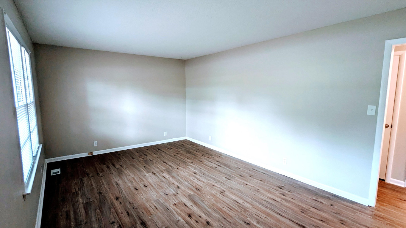 Undisclosed Address Raleigh, NC 27604 - Photo 7 of 32 an empty room with wooden floor and windows